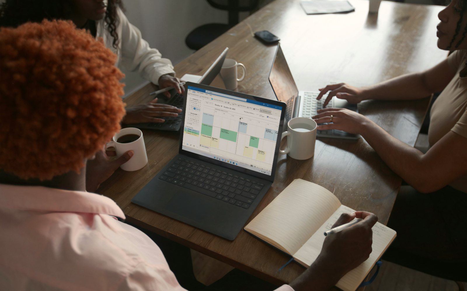 Team planning a schedule together on a laptop